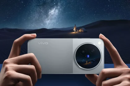 vivo X500 Pro Max в серебристом цвете в руках на фоне ночной пустыни